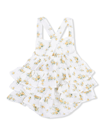 White floral baby dress with ruffled tiers and cross-back straps. Perfect for summer outings.