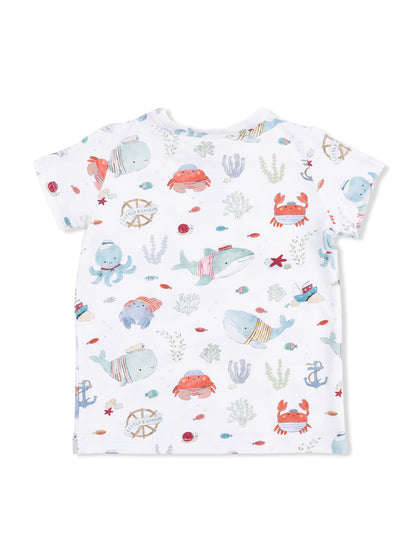 Children's white t-shirt featuring playful sea animal prints, including whales, crabs, and colorful underwater elements.
