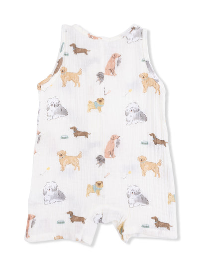 White fabric romper featuring a playful dog print in various breeds and colors. Perfect for dog lovers.