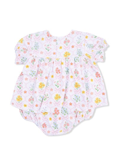Floral-patterned baby romper with short puff sleeves and snap closure at the back, in pastel colors.