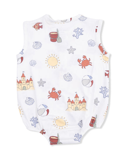 White children's romper featuring beach-themed print: crabs, shells, sun, sand castles, and beach balls.