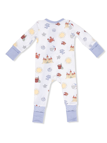 Children's back view of white pajamas with colorful beach-themed prints, including suns, sea creatures, and castles.