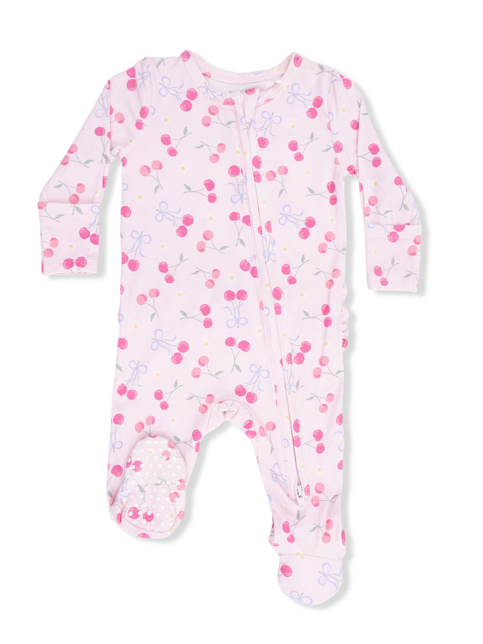Pink baby onesie with cherry and bow patterns, featuring a front zipper and footed design.