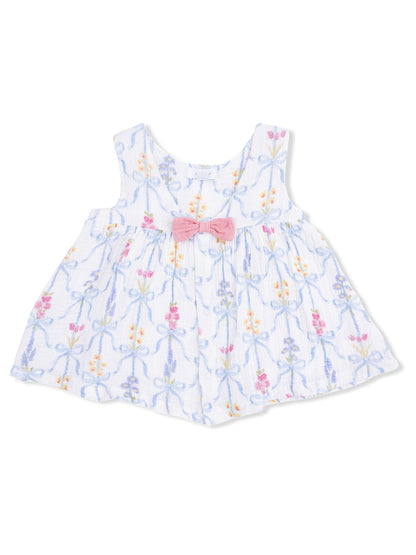White toddler dress with floral patterns and a pink bow at the waist.