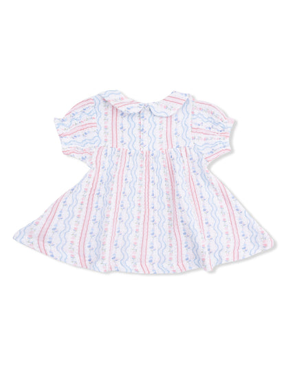 White dress with pink and blue floral patterns and a collar, featuring a flared skirt.