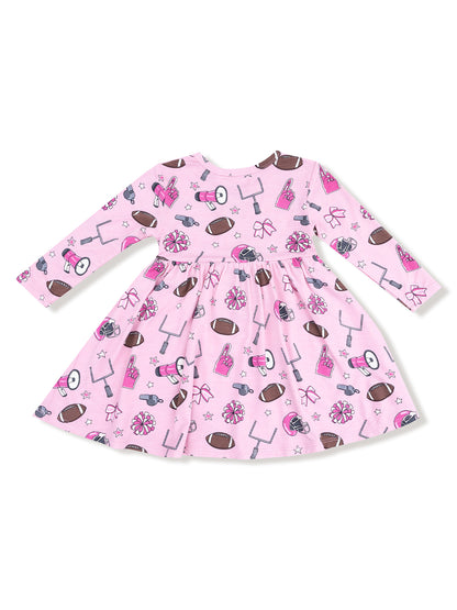 Pink dress with sports-themed prints, including footballs, cheerleading bows, and pom-poms.