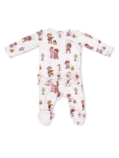 White onesie with colorful cartoon prints of children, cacti, and playful scenes, featuring ruffled detailing.