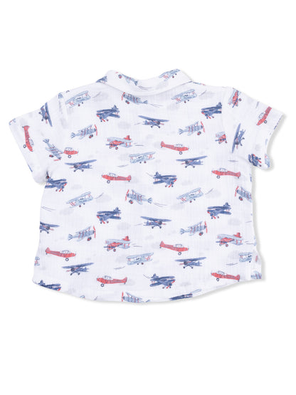Back view of a short-sleeve shirt featuring a colorful airplane print on a white background.