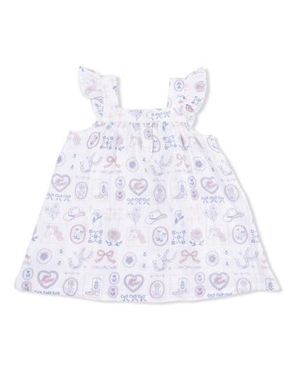 White sleeveless dress with ruffled straps, featuring a colorful western-themed print.