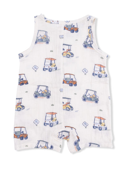 White romper with colorful golf cart patterns on a soft fabric background. Ideal for casual play.