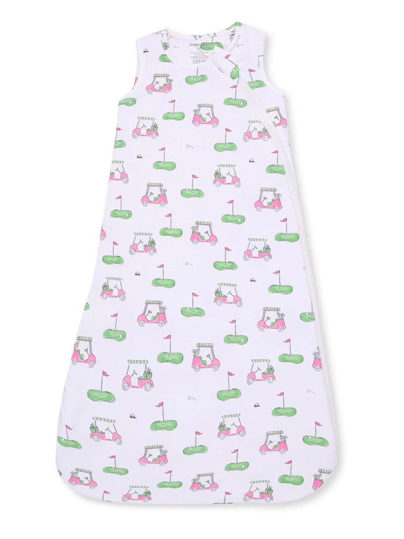White sleeping bag with pink golf cart and grass illustrations, ideal for infants and toddlers.