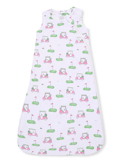 White sleeping bag with pink golf cart and grass illustrations, ideal for infants and toddlers.
