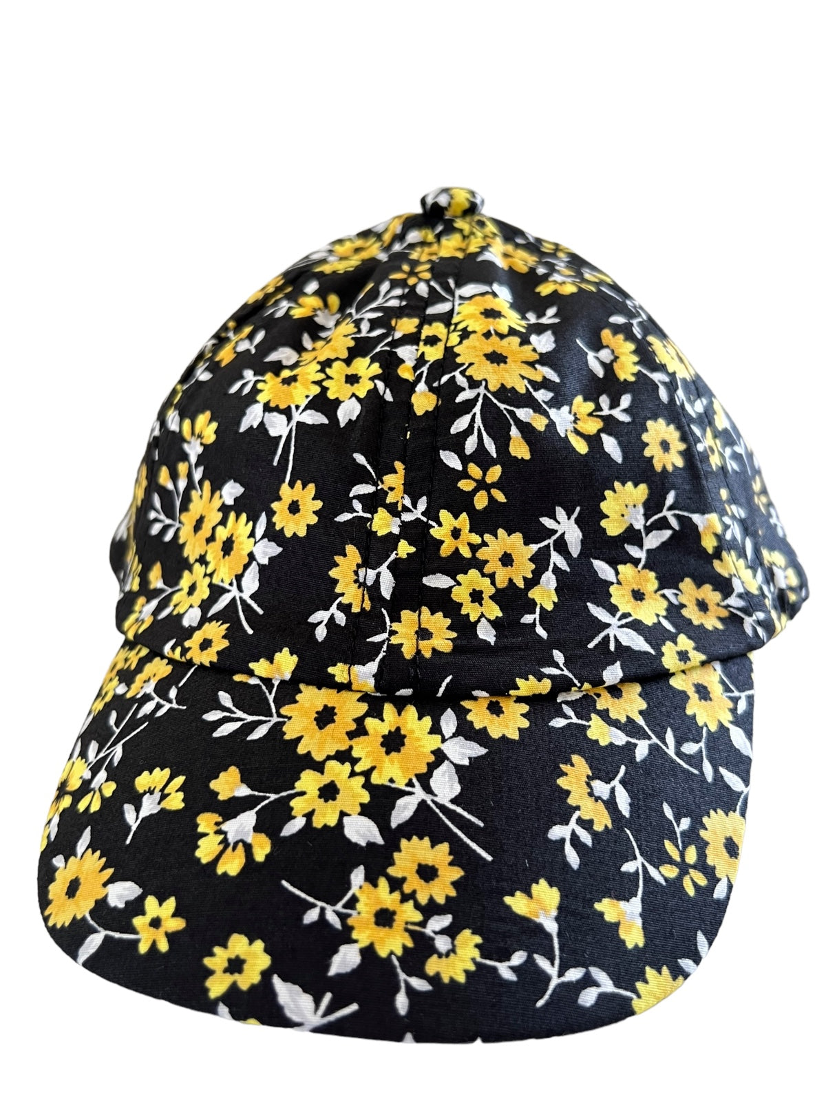 Black cap adorned with yellow flowers and white accents, viewed from the front.