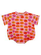 Pink onesie with a playful pumpkin print in orange, pink, and yellow hues. Perfect for fall-themed outfits.