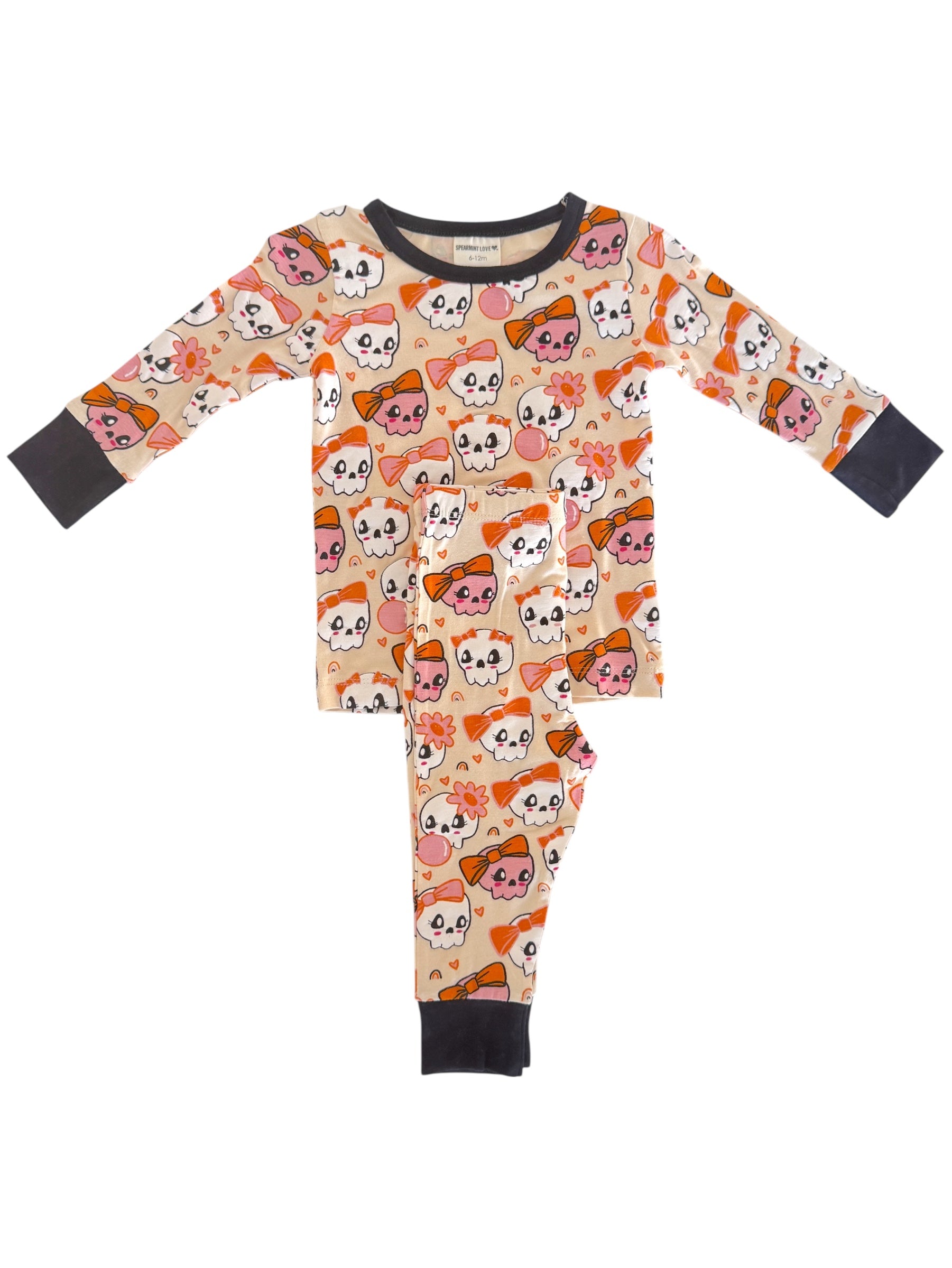 Youth pajamas with playful skull and flower patterns in orange and pink, suitable for casual sleepwear.