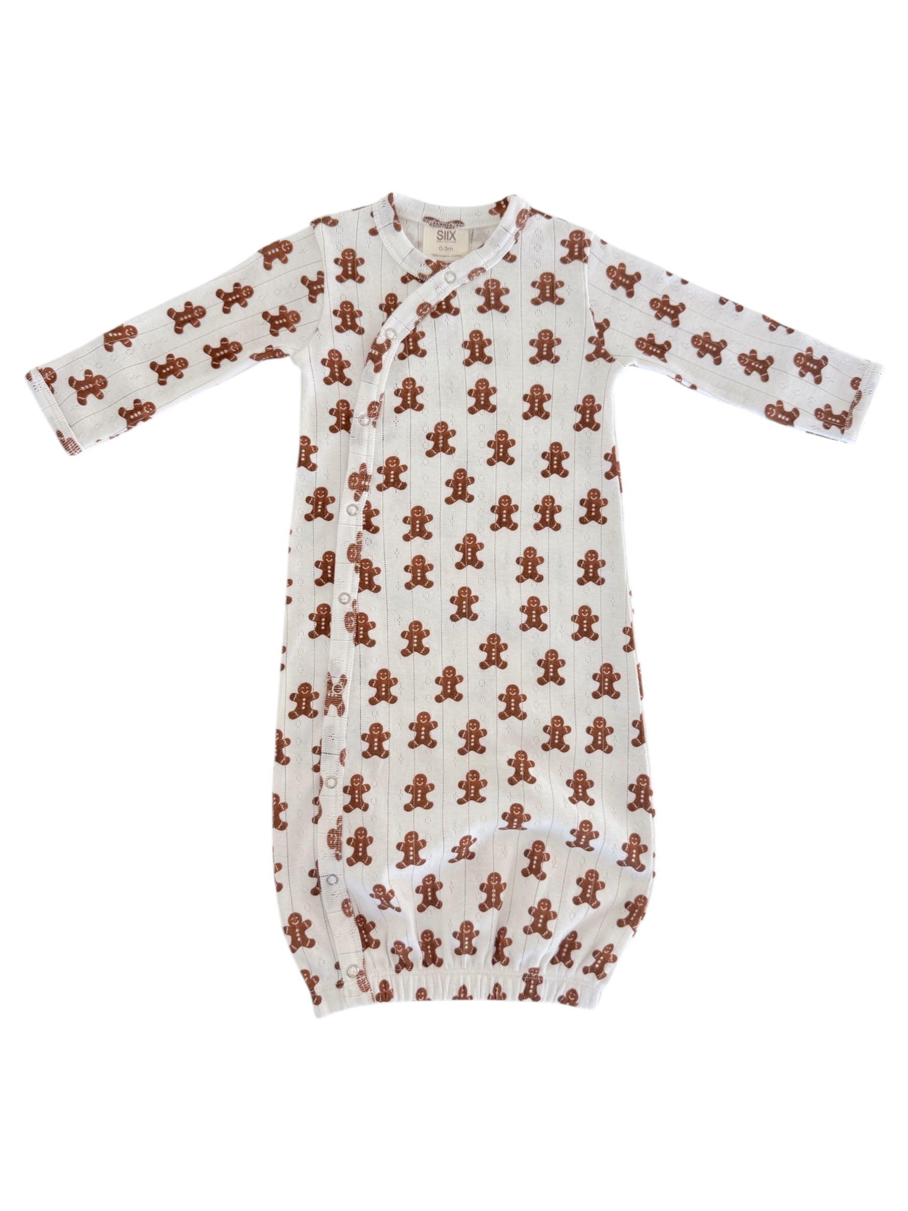 White baby gown with a gingerbread man print, featuring long sleeves and a button closure. Perfect for cozy wear.