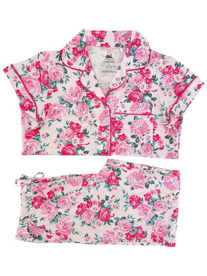 Floral patterned two-piece pajama set in pink and green hues, featuring short sleeves and elastic waistband.