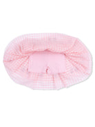 Pink gingham fabric draped over pink shorts, creating a soft, playful outfit layout.