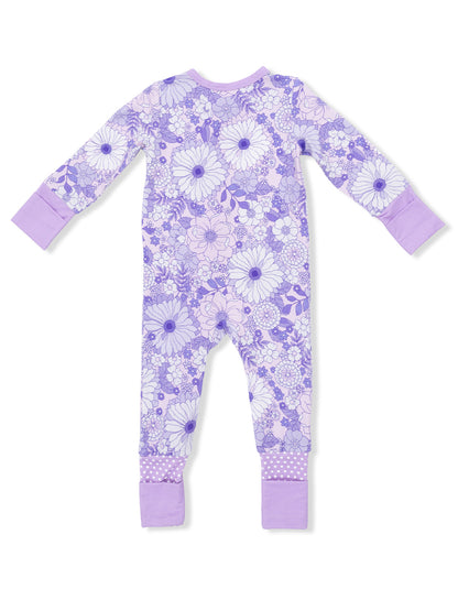 Purple floral onesie with long sleeves and polka dot cuffs, displayed from the back.