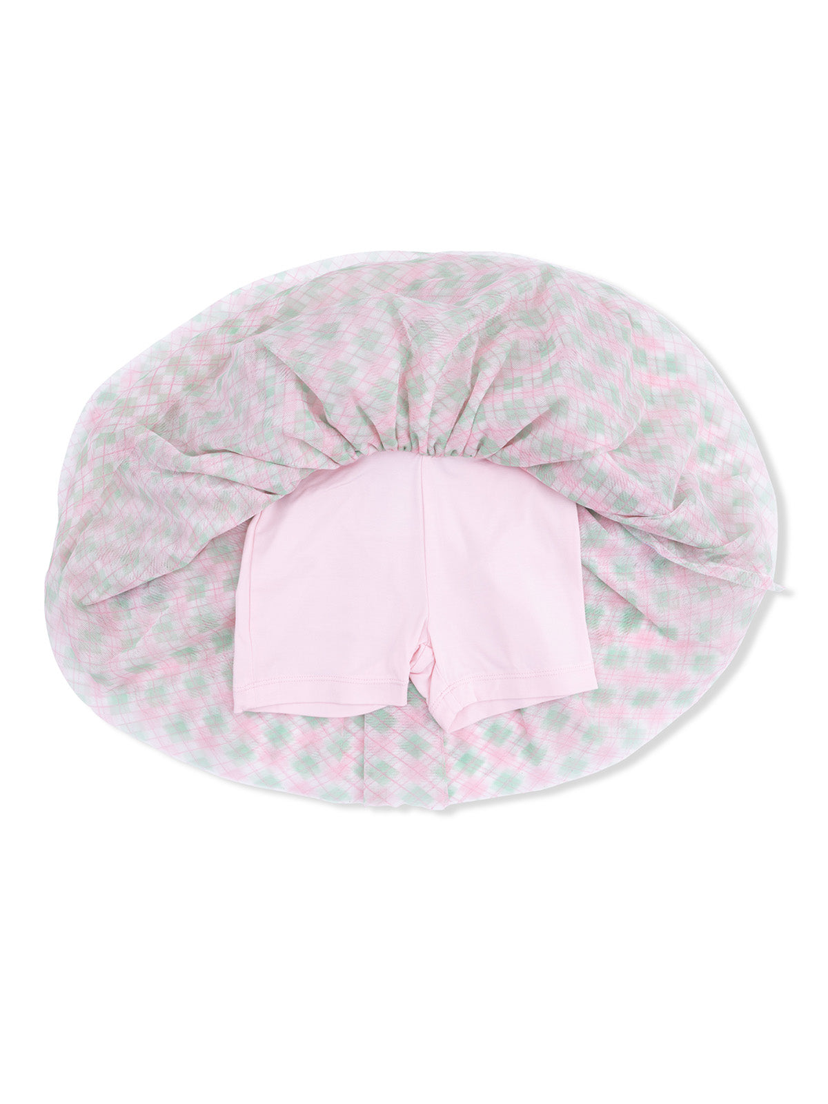Pink shorts lying on top of a pastel plaid blanket, viewed from above.