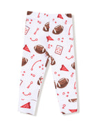 White leggings featuring a playful football print with red accents and game-related symbols.