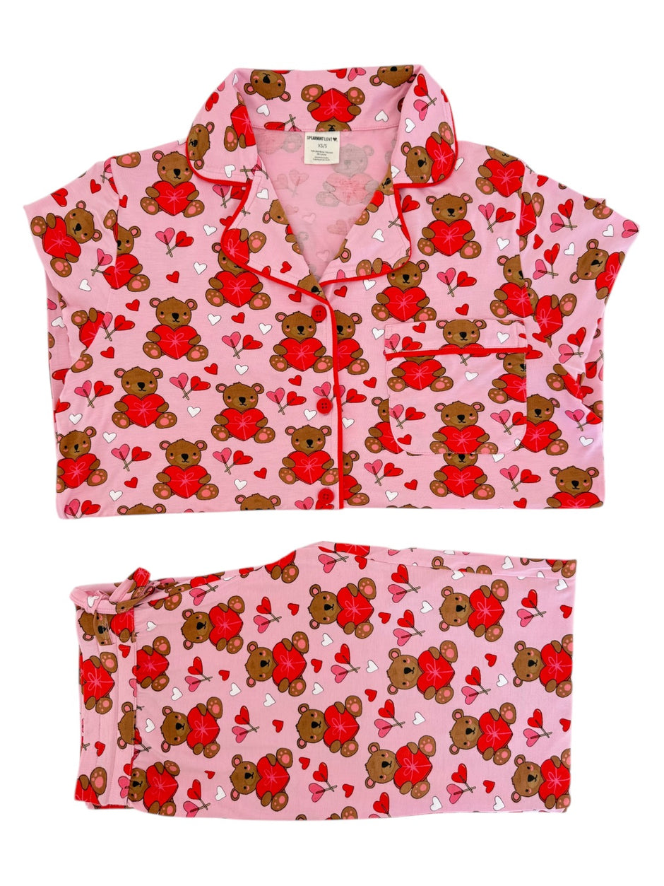 Pink pajama set featuring teddy bears and hearts, perfect for cozy sleepwear.