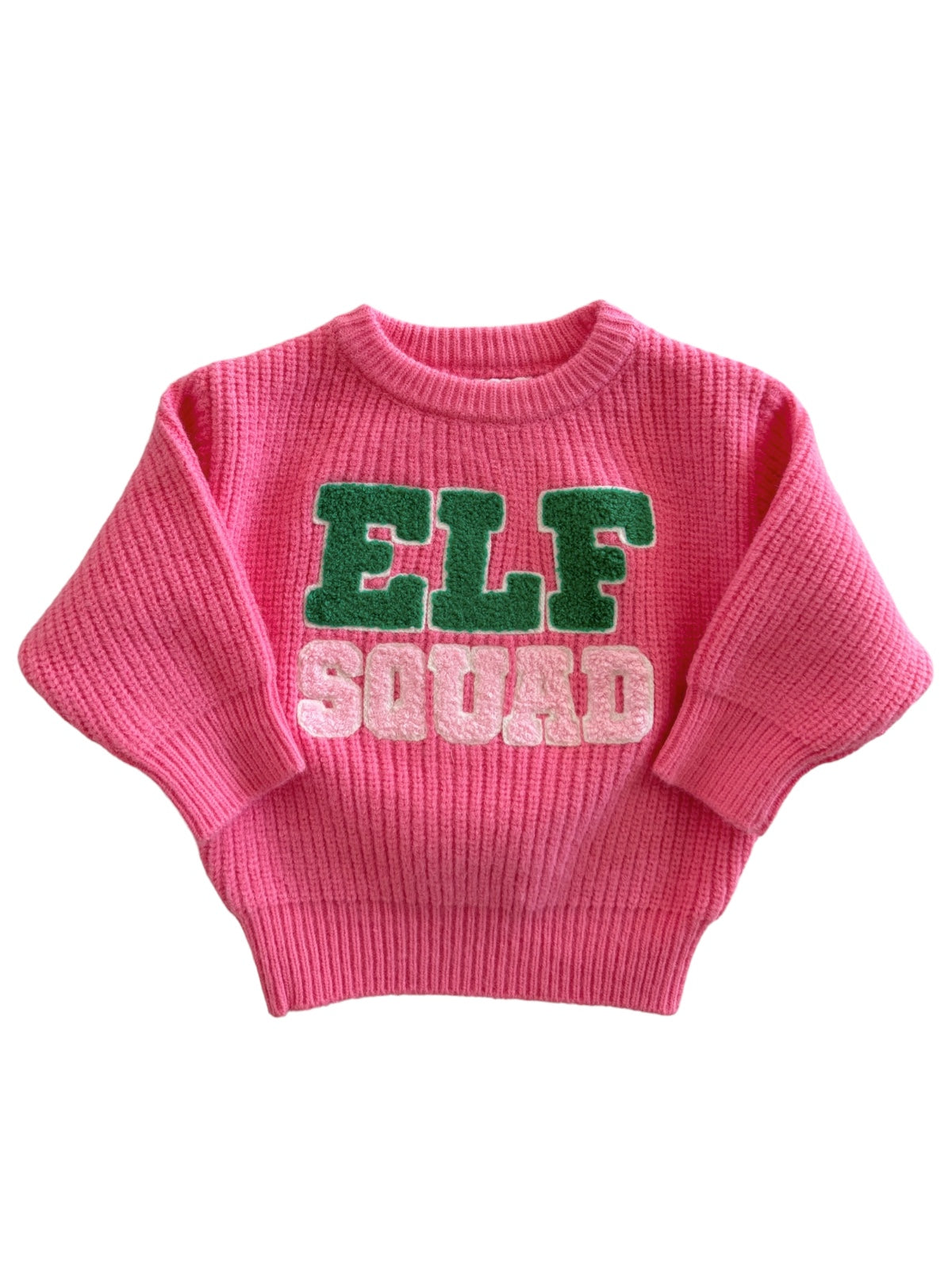Pink sweater with "ELF SQUAD" in green and white letters, featuring a cozy ribbed texture.