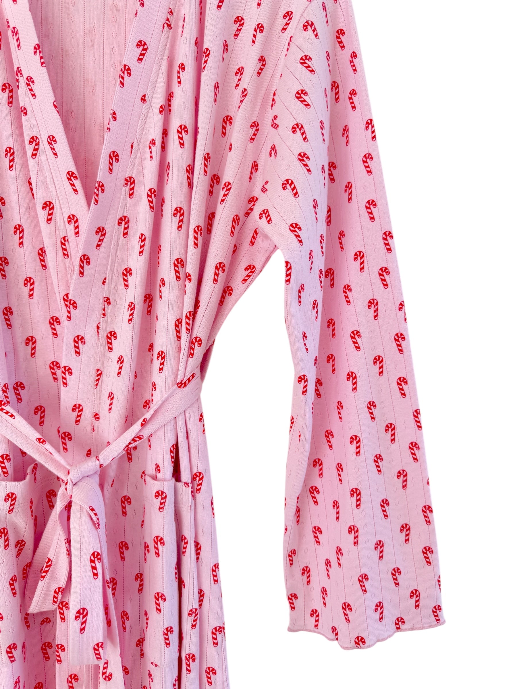 Pink robe with candy cane pattern and tied waist, featuring long sleeves and a relaxed fit.