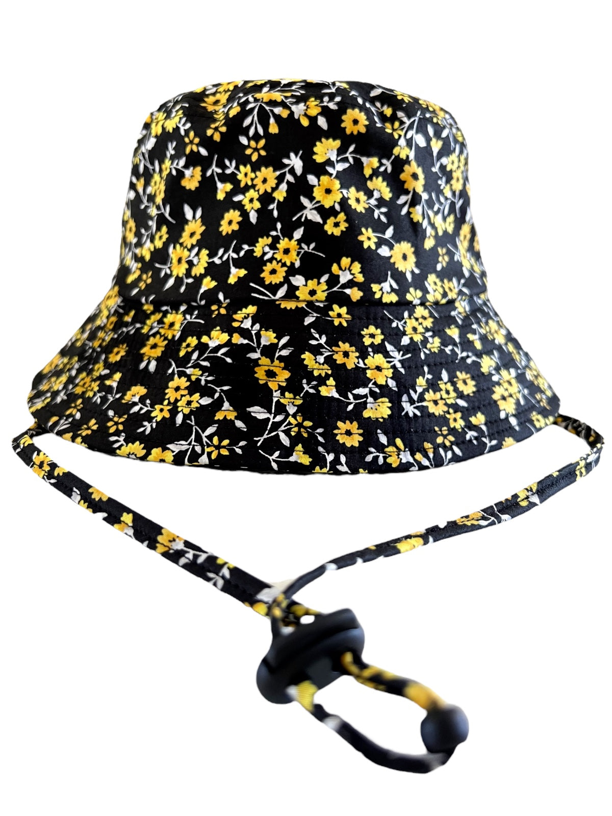 Black bucket hat with yellow flowers and an adjustable chin strap. Ideal for sun protection and casual wear.