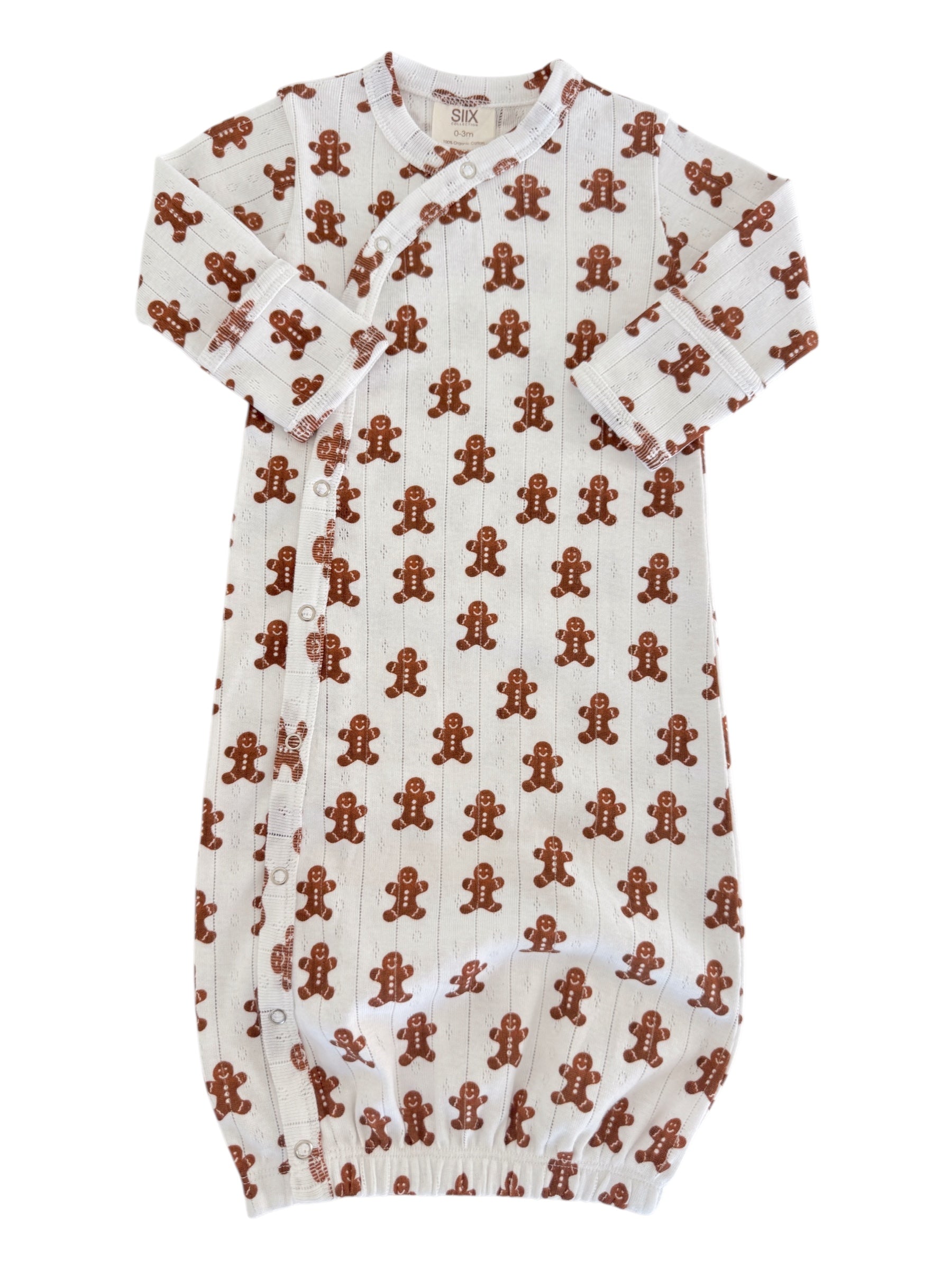Baby gown with gingerbread men pattern on white background, featuring long sleeves and snap closure.