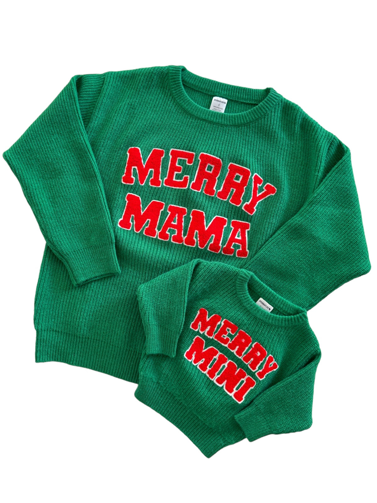 Green matching holiday sweaters for mom and child, featuring “MERRY MAMA” and “MERRY MINI” in bold red letters.