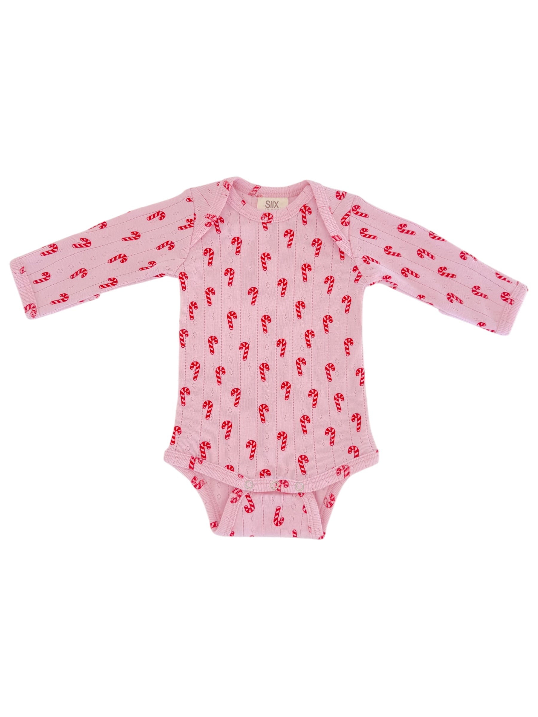 Light pink long-sleeve baby onesie with red candy cane print. Ideal for festive occasions.
