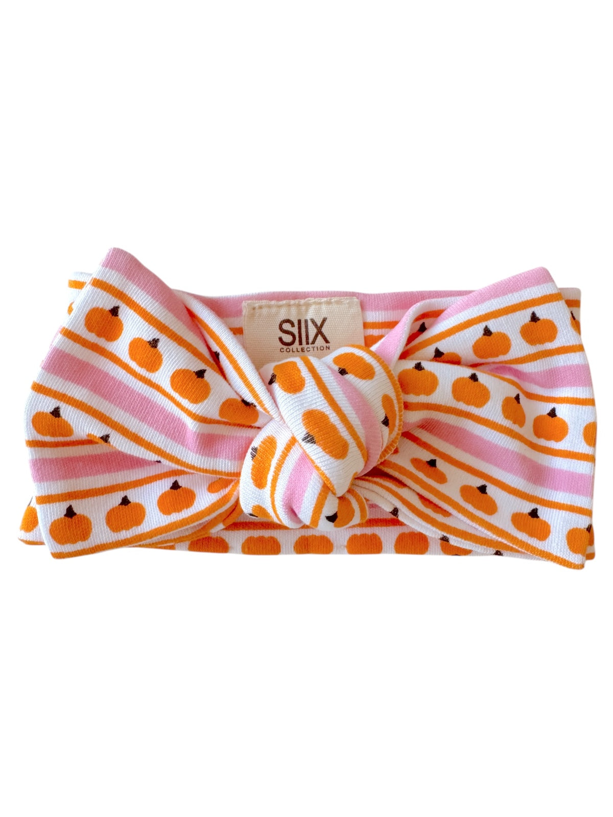 Pumpkin-patterned headband with pink and white stripes, featuring a knot design at the front. 