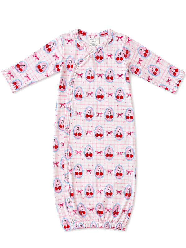 Pink baby gown with cherry and bow patterns, designed for infants 0-3 months, featuring a snap closure.