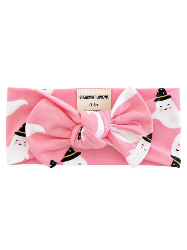 Pink baby headband with ghost patterns and a large bow, designed for infants 0-6 months.
