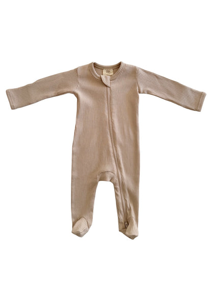 Beige ribbed baby onesie with long sleeves and a front zipper, designed for comfort and ease.
