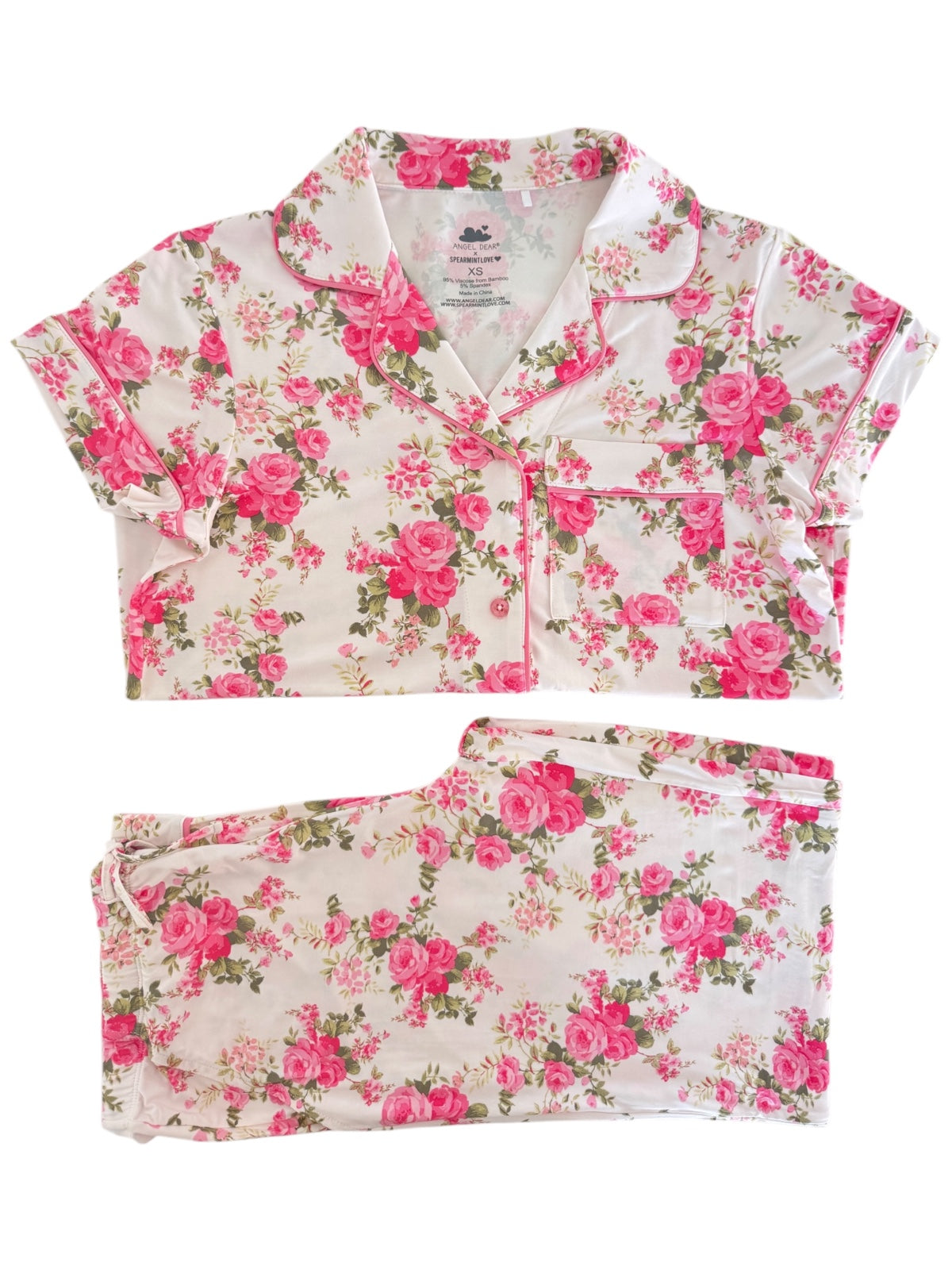 Floral pajama set featuring pink roses on a white background, including a short-sleeve top and matching pants.
