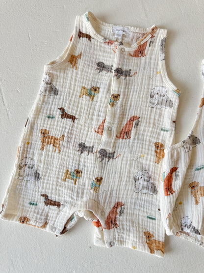 Toddler outfit with a dog print, featuring various dog breeds on a light fabric background.