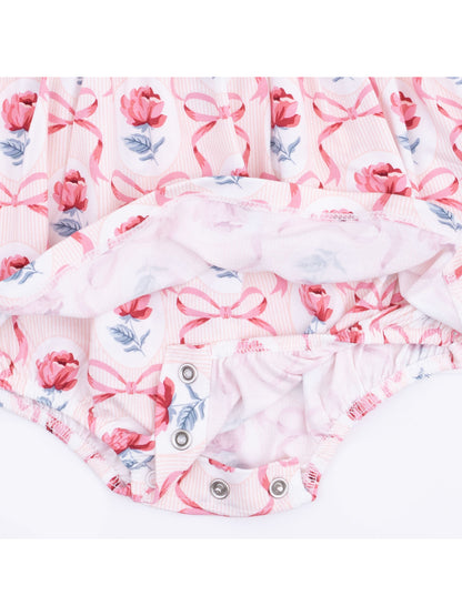 Pink floral baby romper with bows, featuring snap closures at the bottom for easy diaper changes.