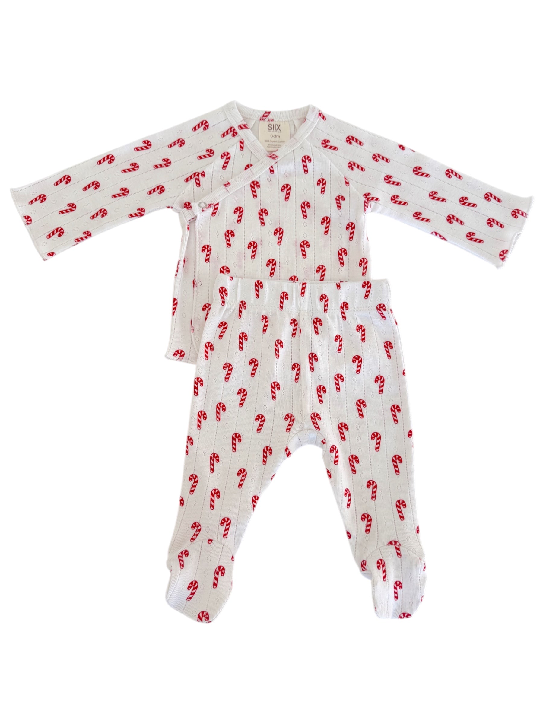 White baby pajama set with red candy cane pattern. Includes long-sleeve top and footed pants.