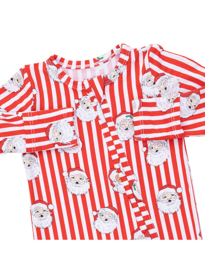 Red and white striped pajamas featuring Santa Claus faces printed throughout. Cozy holiday sleepwear for children.