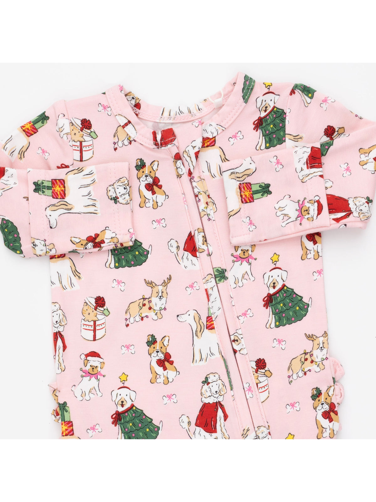 Pink Christmas-themed onesie featuring cartoon dogs in festive attire and decorations.