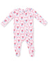 Pink floral infant onesie with long sleeves and front snap closure, featuring roses and ribbons in a playful pattern.