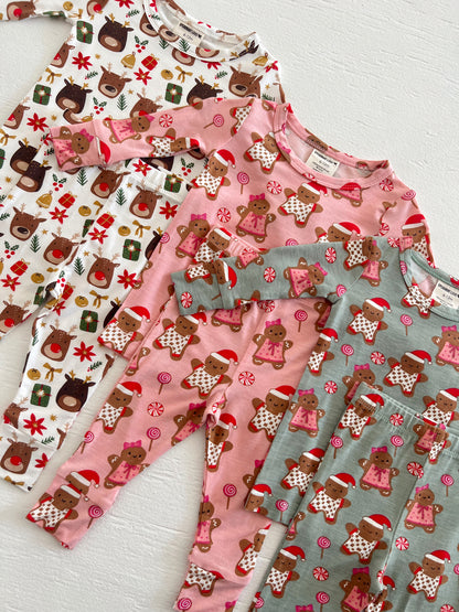 Colorful children's pajamas with holiday themes, featuring reindeer and gingerbread designs.