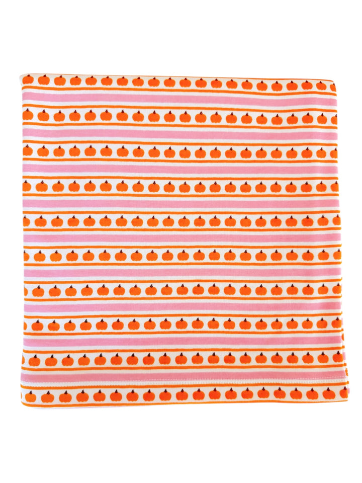 Orange pumpkin pattern on a striped fabric backdrop with pink and white lines. Ideal for autumn themes.