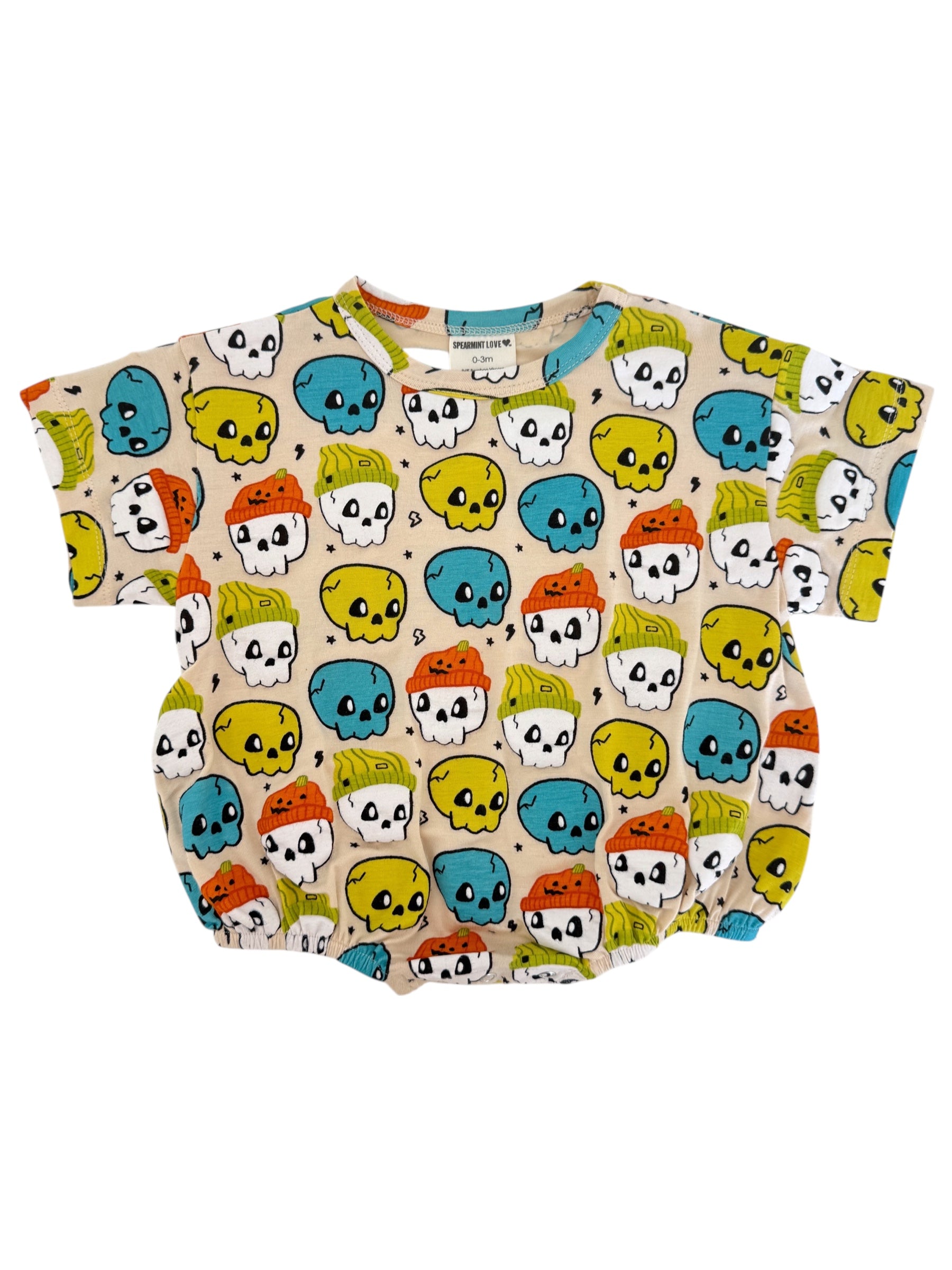 Toddler shirt featuring colorful skulls in blue, yellow, and orange on a beige background, with short sleeves.