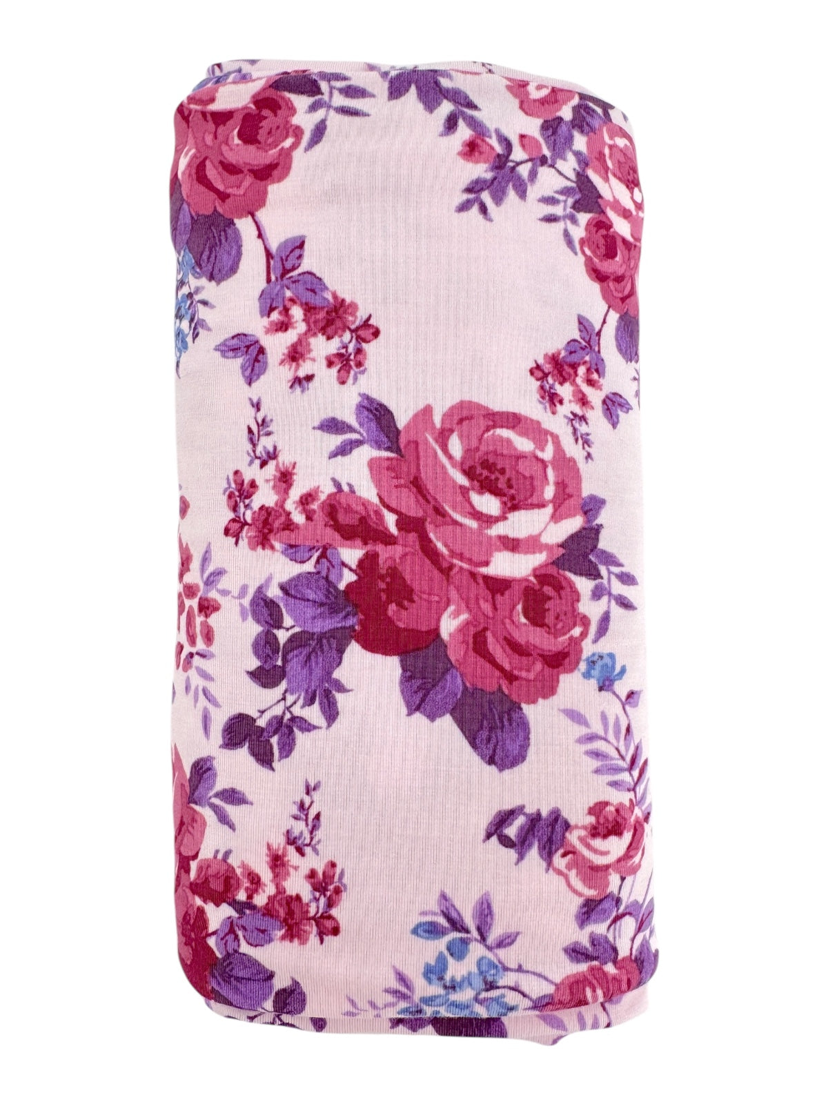 Floral-patterned fabric roll featuring pink roses and purple accents on a light background.