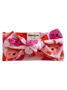 Pink baby headband with cute fruit designs and a knot, labeled "SPEARMINT LOVE," suitable for ages 0-12 months.