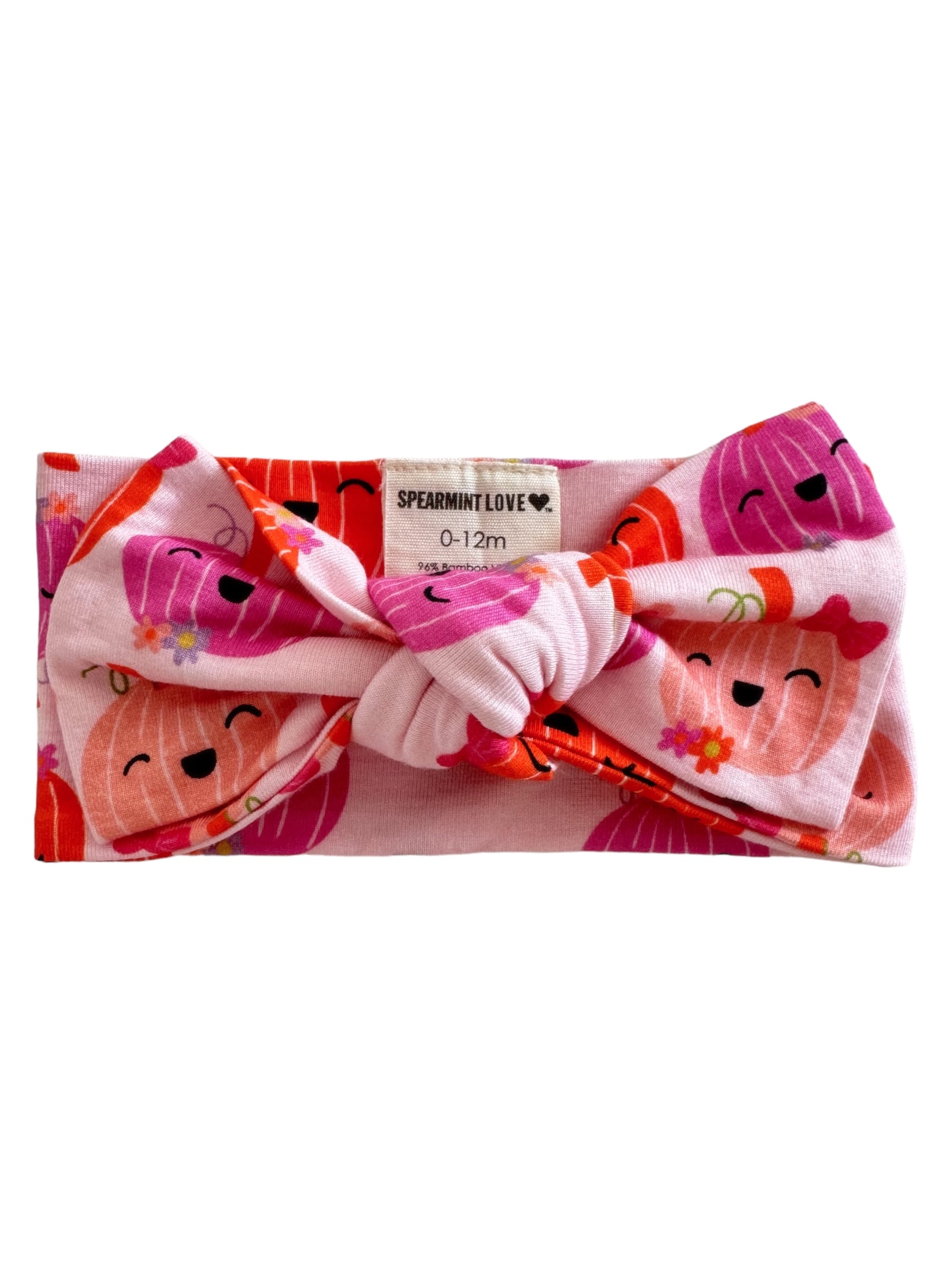 Pink baby headband with cute fruit designs and a knot, labeled "SPEARMINT LOVE," suitable for ages 0-12 months.