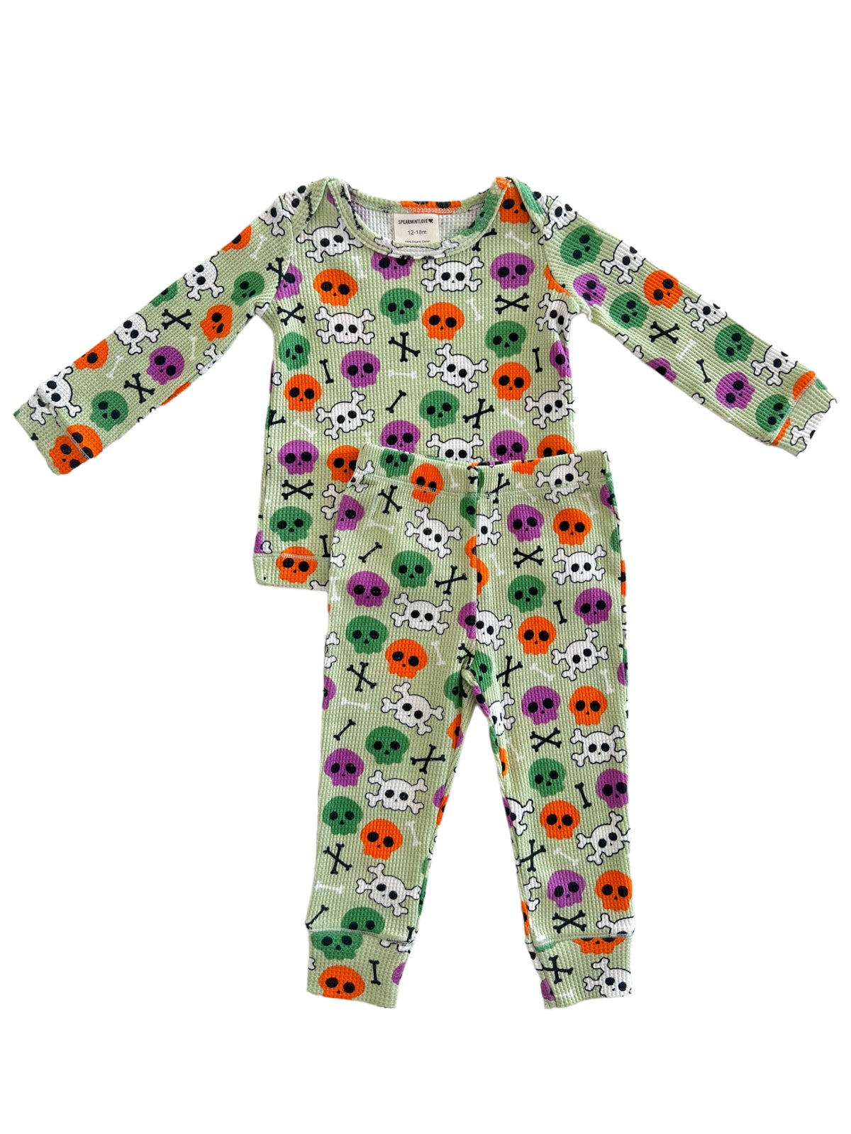 Green pajama set with colorful skull and crossbones pattern in purple, orange, and green. Perfect for Halloween.